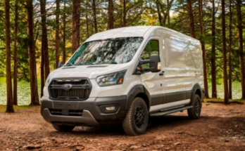 Ford Transit Trail Camper Van parked at a scenic campsite surrounded by nature.